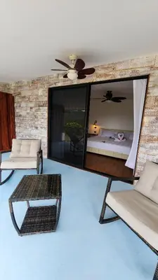a living room with a bed and a mirror at La Puesta del Sol B&B in Carrillo