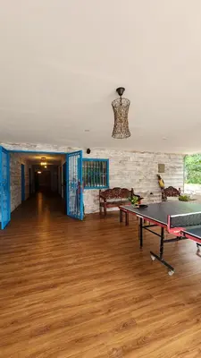 a living room with a ping pong table in it at La Puesta del Sol B&B in Carrillo