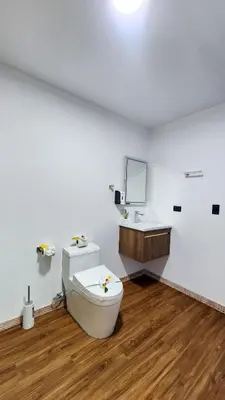 a white bathroom with a toilet and a sink at La Puesta del Sol B&B in Carrillo