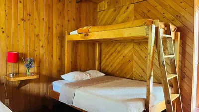 a bedroom with two bunk beds in a cabin at El Toucanet Lodge & Restaurante in El Copey