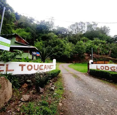 a dirt road with a fence on the side of it at El Toucanet Lodge & Restaurante in El Copey