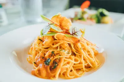 a plate of pasta on a white plate at Hotel Villabosque Eco Boutique in Manuel Antonio