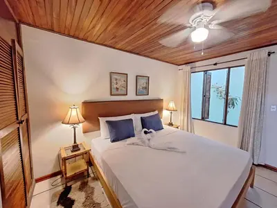 a bedroom with a large white bed and a window at Colours Oasis Resort ADULT ONLY in San José