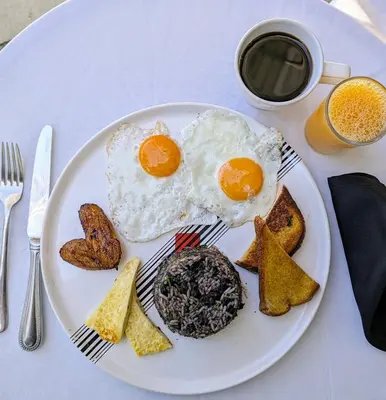 a plate with eggs and toast and a cup of coffee at Colours Oasis Resort ADULT ONLY in San José