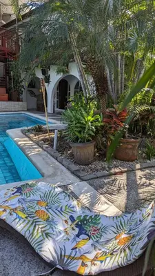 a swimming pool with a colorful table next to a resort at Colours Oasis Resort ADULT ONLY in San José