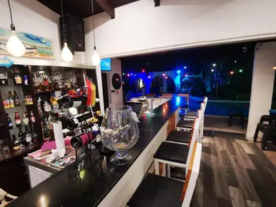 a bar with a counter with a bunch of wine glasses at Colours Oasis Resort ADULT ONLY in San José