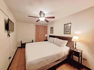 a bedroom with a bed and a ceiling fan at Colours Oasis Resort ADULT ONLY in San José