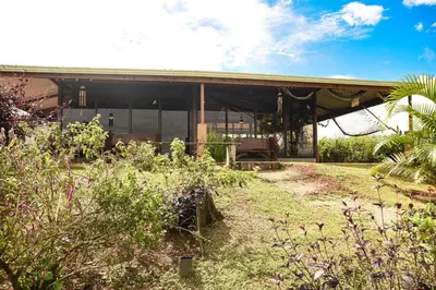 a house with a garden in front of it at Pacuare Mountain Lodge in Tres Equis