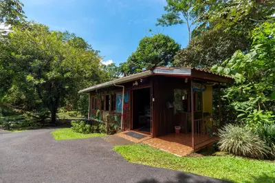 a small building with a porch in the grass at Villas Josipek in Fortuna