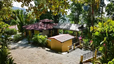 a small building with a roof in the dirt at Villas by Tekoa in Uvita