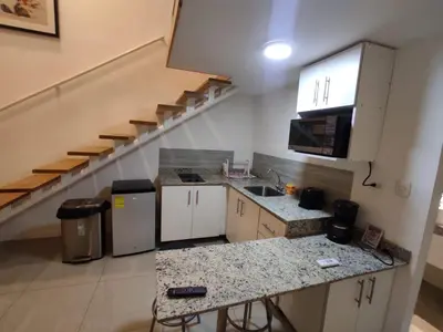 a kitchen with a sink and a staircase at Apartahotel Altos de la Sabana in San José