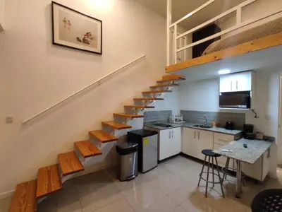 a kitchen with a staircase in a house at Apartahotel Altos de la Sabana in San José