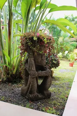 a garden statue with a plant on top of it at Hotel Arte Natura in Fortuna