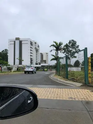 a car driving down a road with a fence at Cozy apartment near to Costa Rica Airport in Heredia