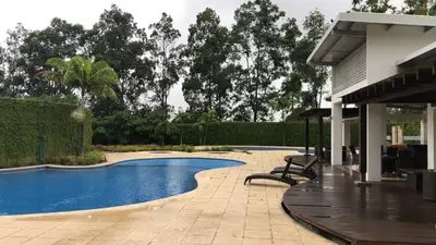 a swimming pool in a yard next to a house at Cozy apartment near to Costa Rica Airport in Heredia