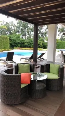 a patio with a table and chairs and a pool at Cozy apartment near to Costa Rica Airport in Heredia