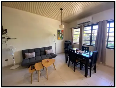 a living room with a couch and a table and chairs at Beach Break Santa Teresa Apartamentos in Santa Teresa Beach