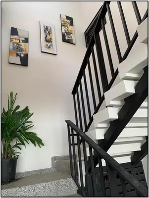 a black and white staircase with pictures on the wall at Beach Break Santa Teresa Apartamentos in Santa Teresa Beach