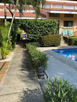 a resort with a swimming pool next to a building at Spacious Loft with Pool and Great Outdoor Areas in Coco