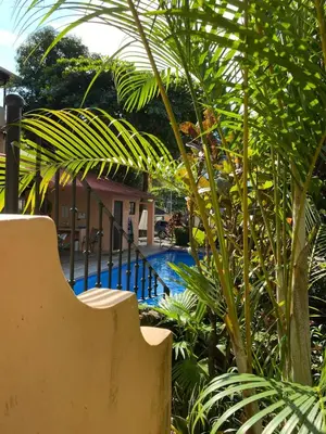 a resort with a swimming pool and palm trees at Spacious Loft with Pool and Great Outdoor Areas in Coco