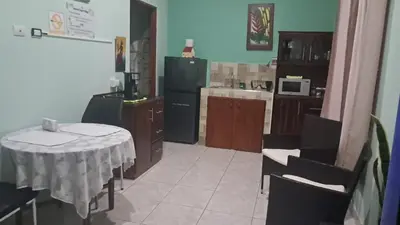 a kitchen with a table and chairs and a kitchen with a refrigerator at apartamento 3 in Fortuna