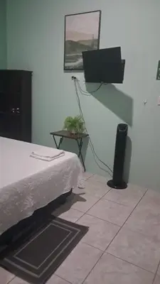 a bedroom with a bed and a tv on the wall at apartamento 3 in Fortuna
