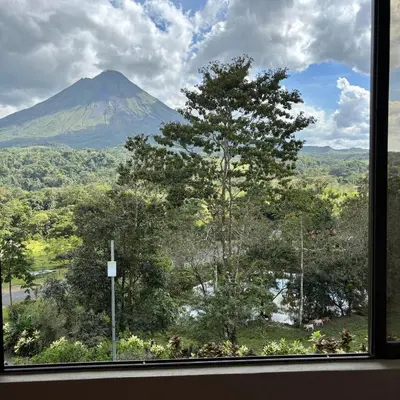 a view of a mountain from a window at Arenal Roca Lodge & Bungalows in Fortuna