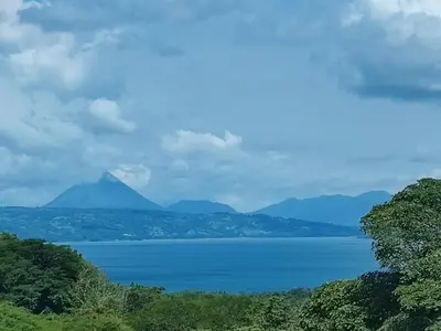 a view of a lake with mountains in the background at La Ceiba Tree Lodge in Tilarán