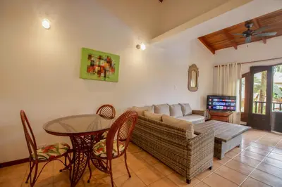 a living room with a couch and a table at Apartotel Girasol in Jacó