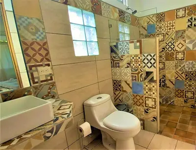 a bathroom with a toilet and a sink at Hotel Pura Natura Beachfront Tortuguero in Tortuguero