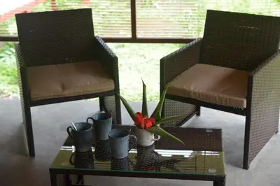 two chairs and a table with a flower on it at Villasjungle 1 in Sámara