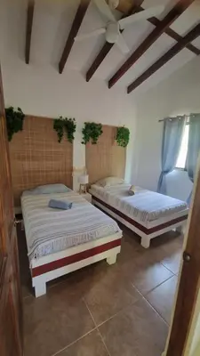 two beds sitting in a room with at Villasjungle 2 in Sámara
