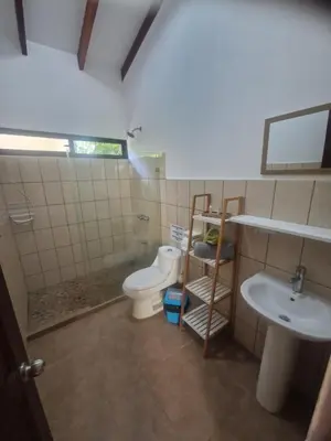 a bathroom with a toilet and a sink at Villasjungle 2 in Sámara