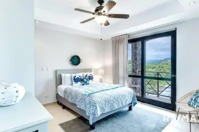 a bedroom with a bed and a large window at 777J Beachfront Luxury Condo 3 BR/2.5BA Near SJO - Jaco Beach in Jacó