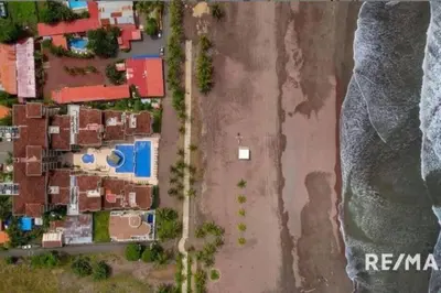an aerial view of a beach with houses and the ocean at 777J Beachfront Luxury Condo 3 BR/2.5BA Near SJO - Jaco Beach in Jacó