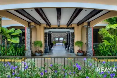 a hallway with plants and purple flowers at 777J Beachfront Luxury Condo 3 BR/2.5BA Near SJO - Jaco Beach in Jacó
