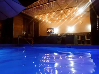 a swimming pool in a room with lights at Casa Linda in Uvita