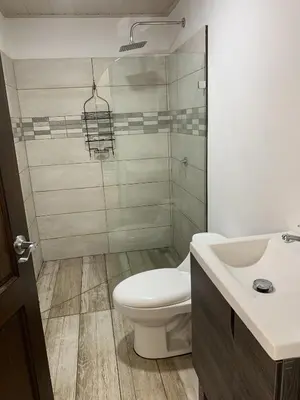 a bathroom with a toilet and a sink at Casa Linda in Uvita
