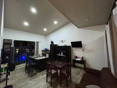 a living room with a table and a dining room at Casa Linda in Uvita