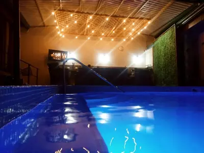 a swimming pool in a room with lights at Casa Linda in Uvita