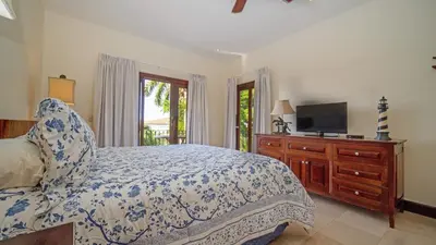 a bedroom with a bed and a flat screen tv at Villa Zindagi Luxury Villa Private Pool - Reserva Conchal in Playa Conchal