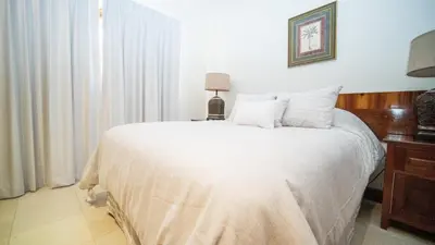 a bedroom with a large bed with white sheets at Villa Zindagi Luxury Villa Private Pool - Reserva Conchal in Playa Conchal