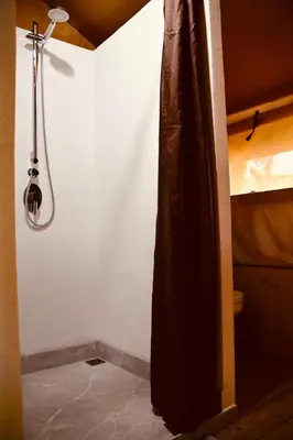 a bathroom with a shower in a room at El Pulpo Safari Lodge in Ojochal