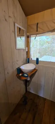 a bathroom with a sink and a window in a room at El Pulpo Safari Lodge in Ojochal
