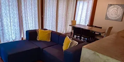 a living room with a blue couch with yellow pillows at Beach Walk Costa Rica in Playa Avellana