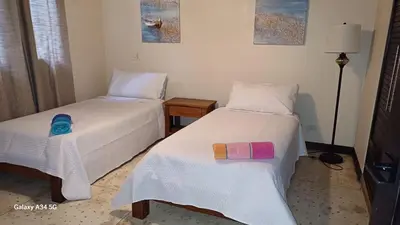 a bedroom with two beds with towels on them at Beach Walk Costa Rica in Playa Avellana