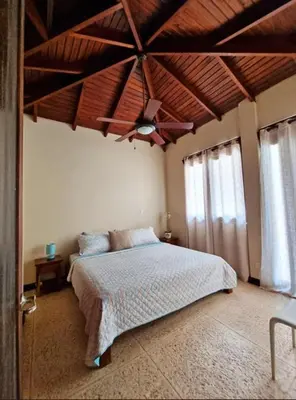 a bedroom with a bed and a wooden ceiling at Beach Walk Costa Rica in Playa Avellana