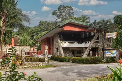 a building with a sign in front of it at Hotel Playa Bejuco in Esterillos Este