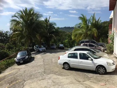 a group of cars parked in a parking lot at Hotel Coco Beach in Manuel Antonio