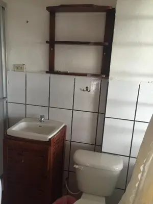 a bathroom with a toilet and a sink at Hotel Coco Beach in Manuel Antonio